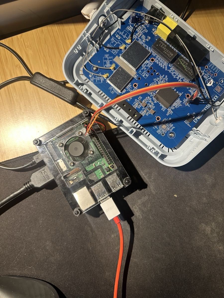 D-Link AX-1500 router torn open, exposing the board and UART pins